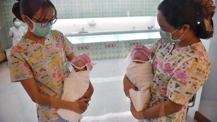 PHOTO. COVID-19: Newborns at Thailand Hospital are given face shields to protect from virus